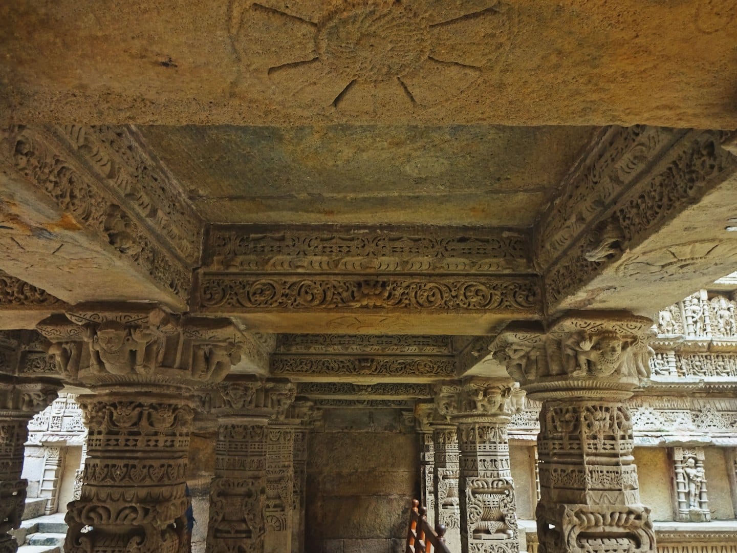 Intricate stone carvings and ornate columns inside an ancient temple.